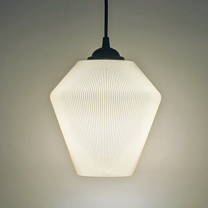 The Inversis Pendant Light by Dryft Home is a modern, minimalist fixture made from sustainable materials. It features a textured geometric shade that casts a soft, warm glow against plain backgrounds, creating a cozy ambiance.